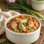 Bowl of homemade chicken, brown rice, carrots, and peas for dogs